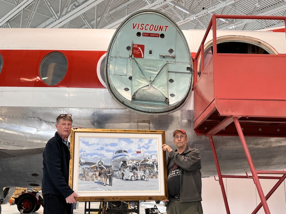 CEO Terry Slobodian and Robert Arnold, RAMWC volunteer, with Jim Bruce's painting, 'Pre-Flight'