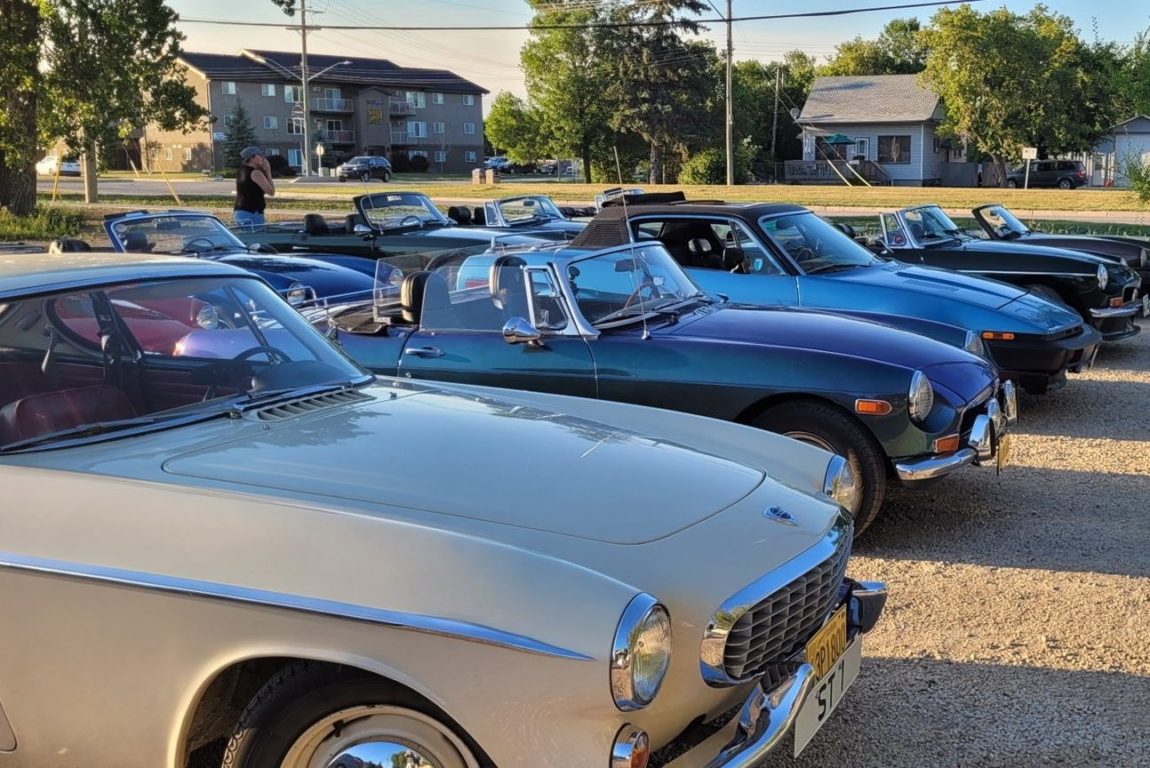 Classic British cars parked in a row at a car show
