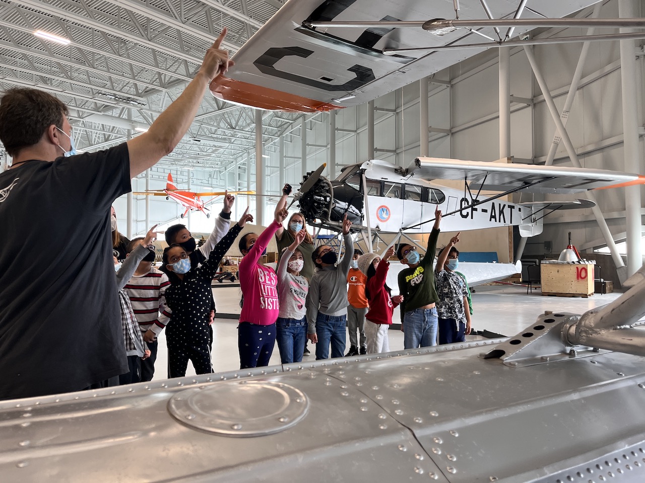 A group of young students receives at tour at the Royal Aviation Museum