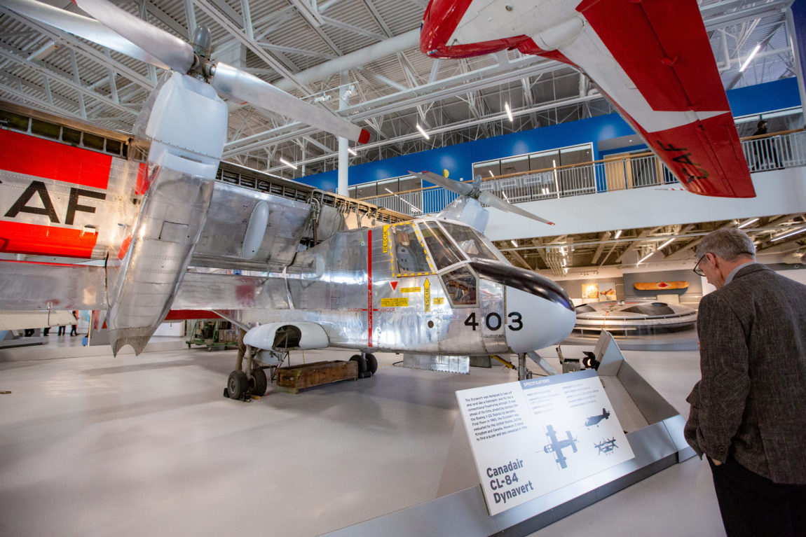 a large silver aircraft on display inside a museum