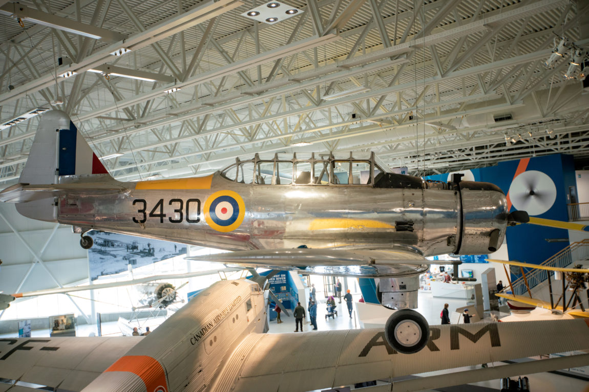 view of an antique aircraft from the second floor of a museum