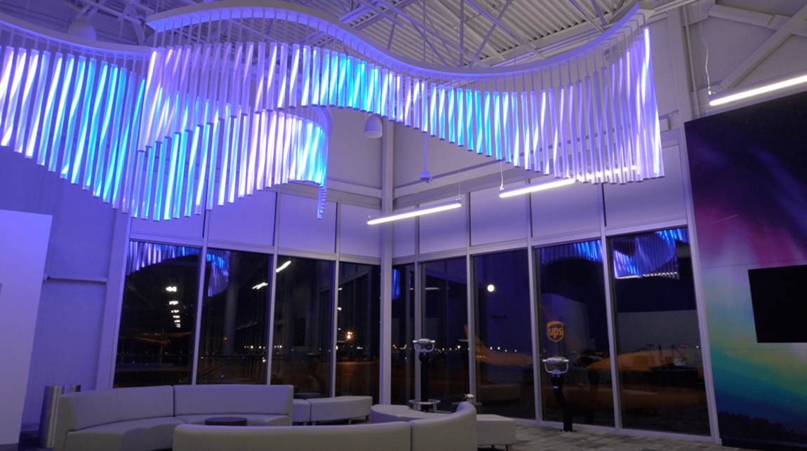 an aurora borealis sculpture lights up an lounge area