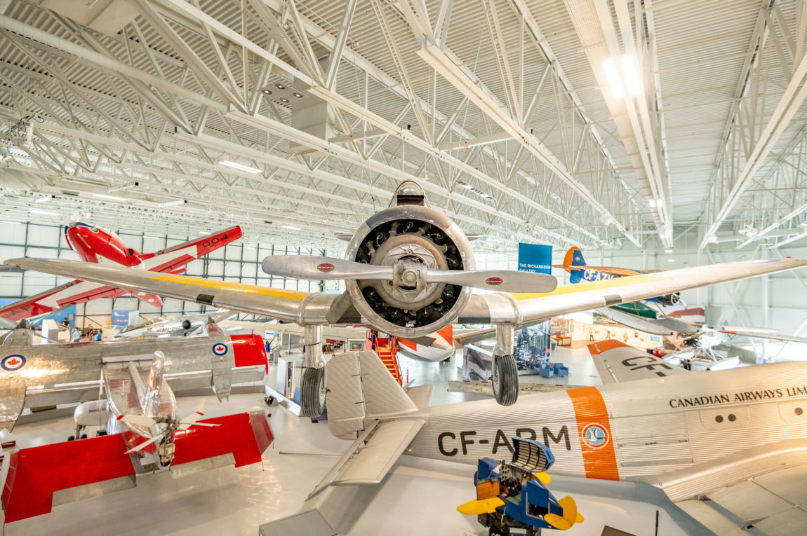 view of a museum floor filled with aircraft