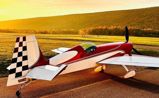 Luke Penner's new Extra 330SC aerobatic plane sits on a runway at golden hour