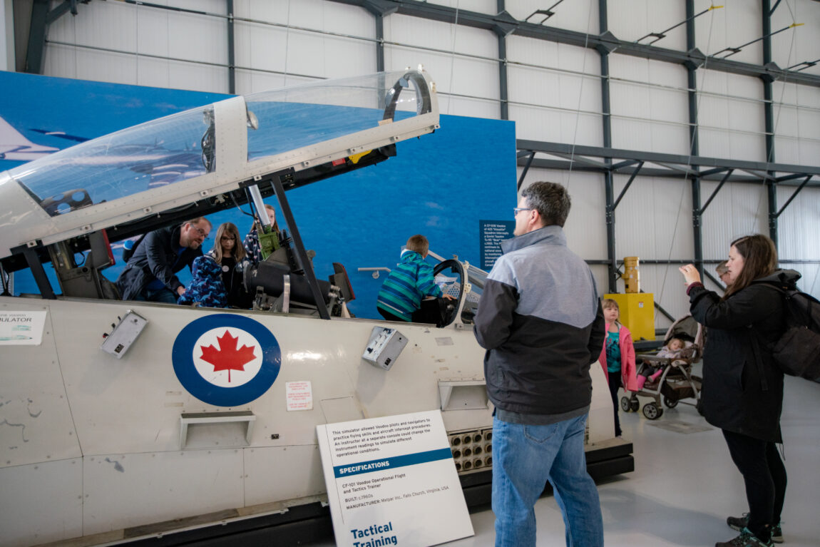 Young visitors check out the Voodoo simulator and parents take photos the Royal Aviation Museum's grand opening event.