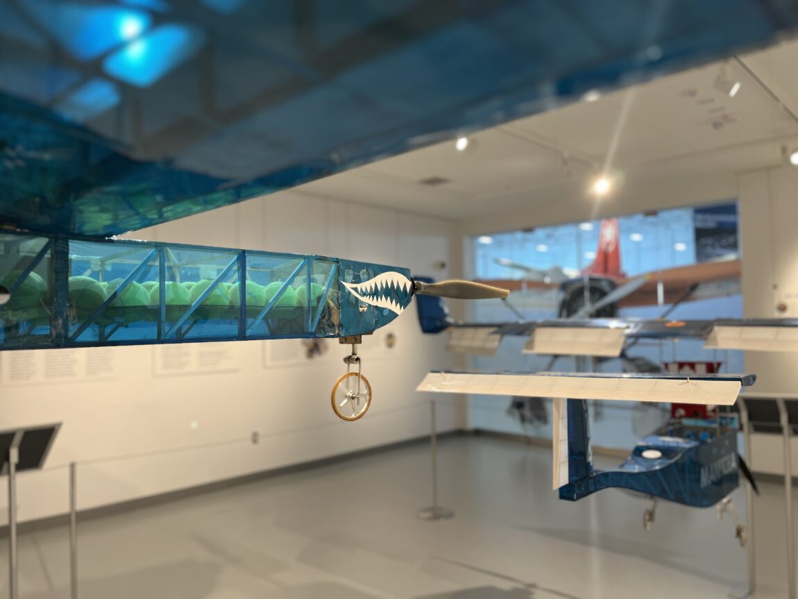 Two remote-controlled aircraft hang suspended from the ceiling of the Hastings Family Gallery at the Royal Aviation Museum of Western Canada