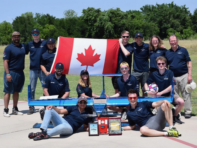 Engineering students from the University of Manitoba pose with the Canadian flag and their winning remote-controlled aircraft