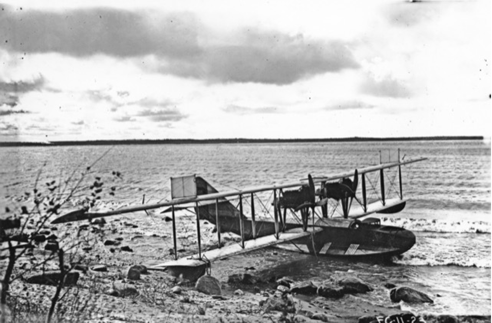 A Curtiss H-16 flying boat sits in the waters of Lake Winnipeg at Victoria Beach.