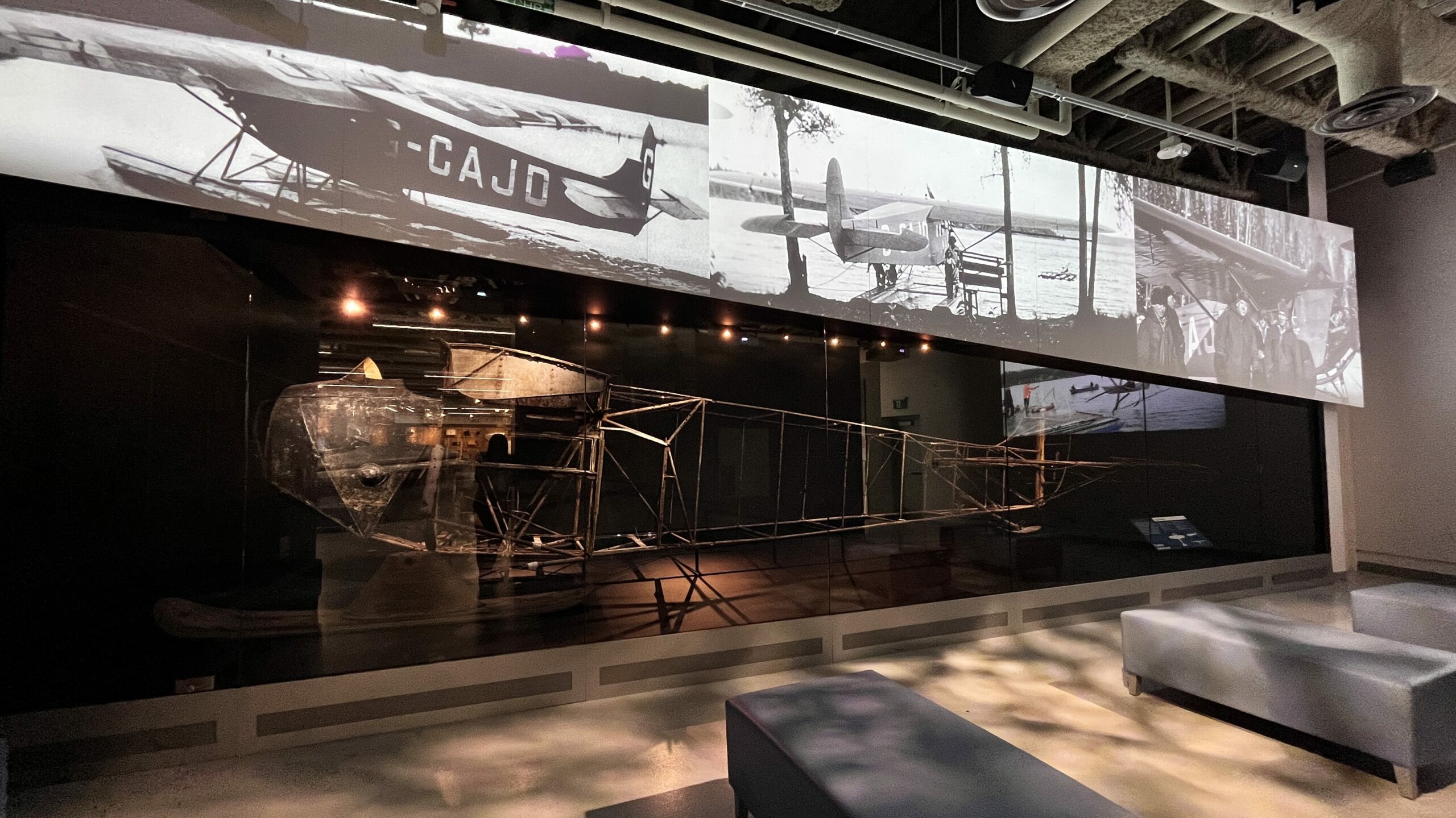 The Fokker Universal, G-CAJD, aka The Ghost of Charron Lake, sits behind glass at the Royal Aviation Museum of Western Canada