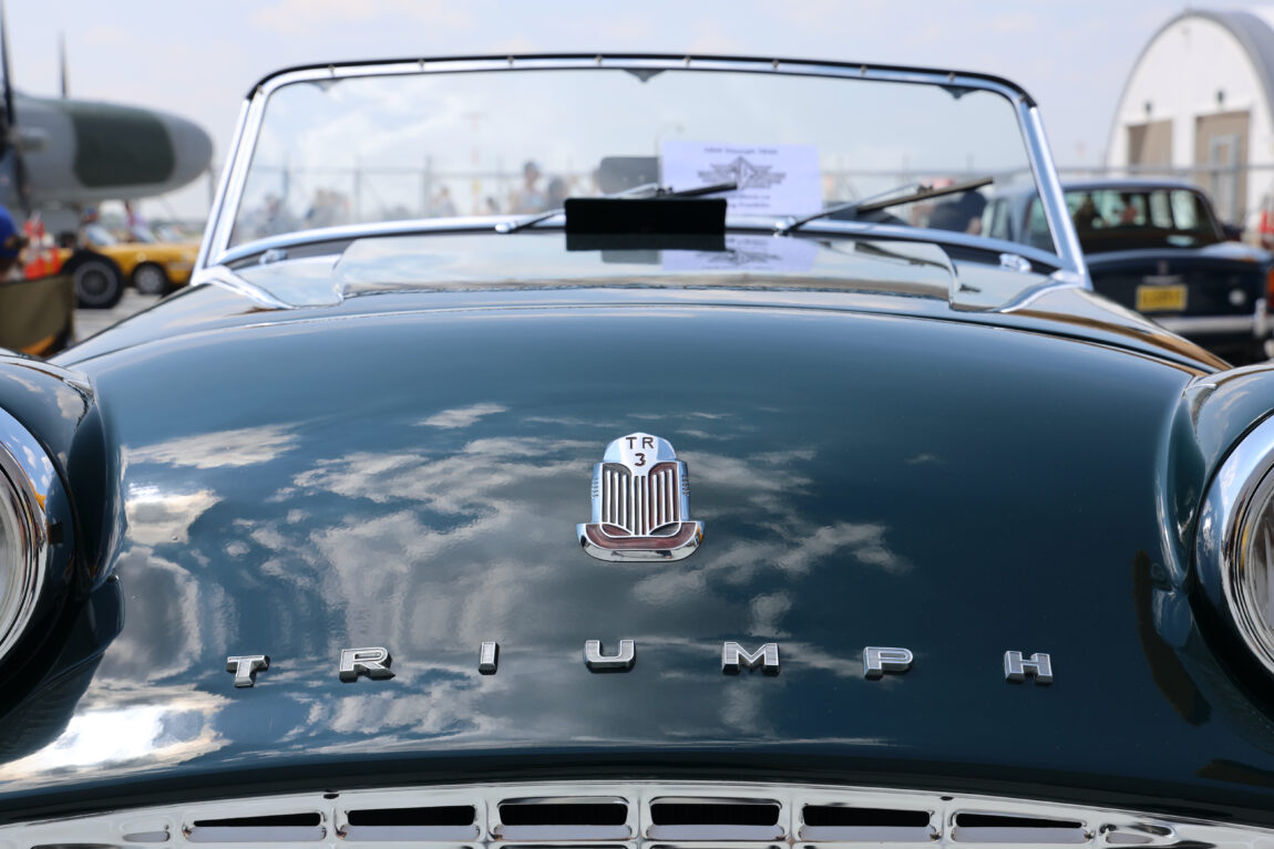 Close-up of the back of a dark green Triumph automobile on display for Wings and Wheels at the Royal Aviation Museum