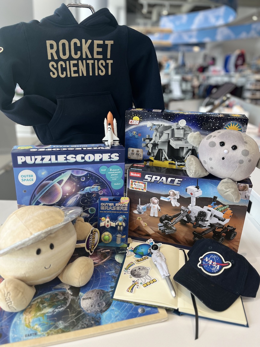 display of space-themed children's toys, clothing, and games