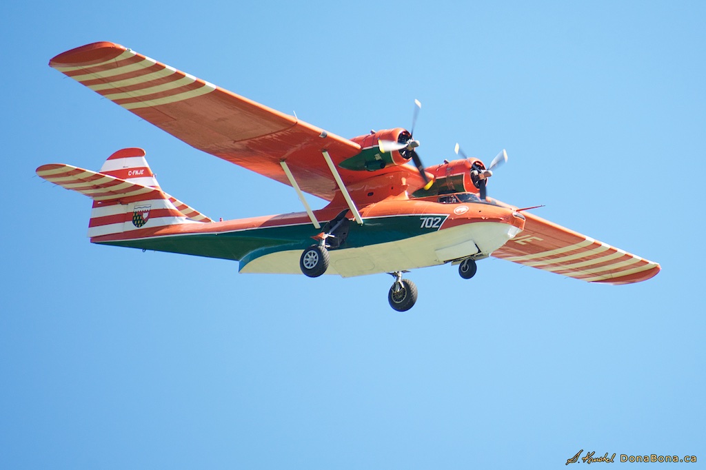 Canso aircraft in flight against a bright blue sky