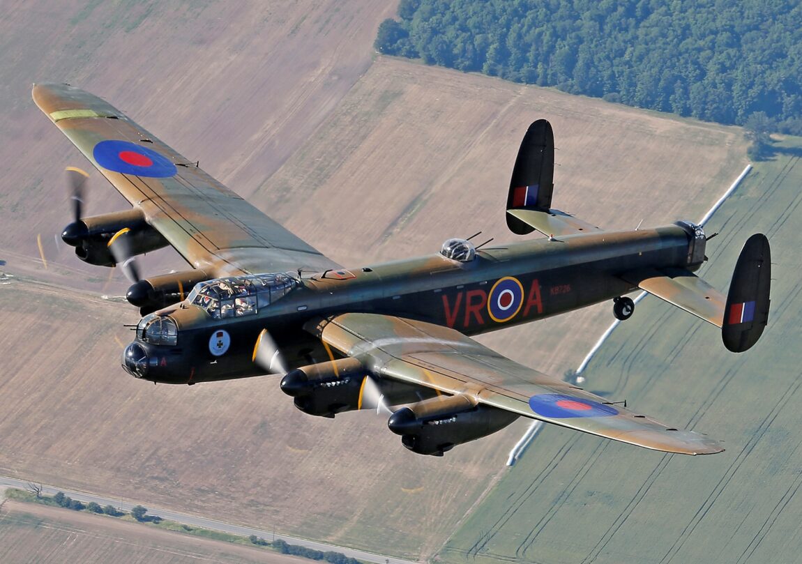Avro Lancaster C-GVRA flies over a patchwork landscape